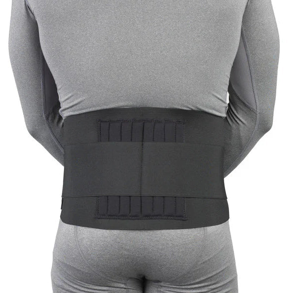 Person wearing a gray long-sleeve shirt and shorts with a black back brace on a white background - okotoks hc pharmacy