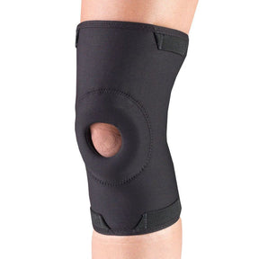 Black knee brace on a person's knee against a white background - okotoks hc pharmacy