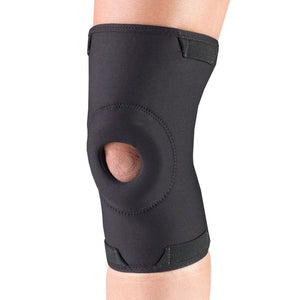 Black knee brace on a person's knee against a white background - okotoks hc pharmacy
