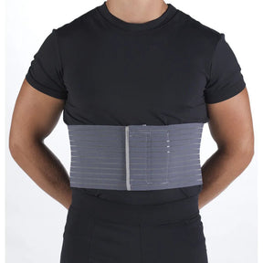 Person wearing a black shirt with a gray compression wrap on the torso against a white background - okotoks hc pharmacy