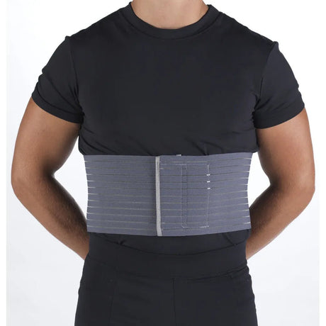 Person wearing a black shirt with a gray compression wrap on the torso against a white background - okotoks hc pharmacy