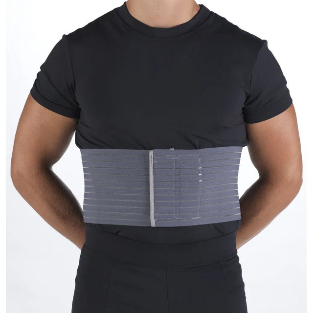 Person wearing a black shirt with a gray compression wrap on the torso against a white background - okotoks hc pharmacy