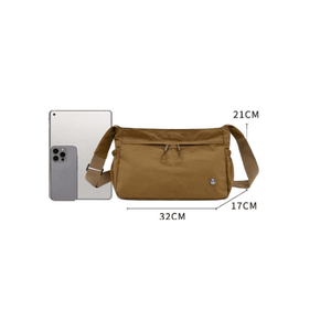 Brown shoulder bag with measurements next to a smartphone on a white background - okotoks hc pharmacy