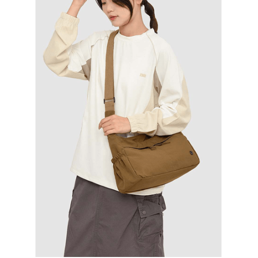 Person wearing a beige shirt and brown pants holding a brown bag against a white background - okotoks hc pharmacy