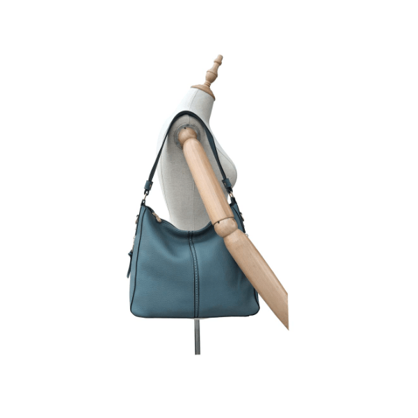 Blue handbag on a mannequin against a white background - okotoks hc pharmacy