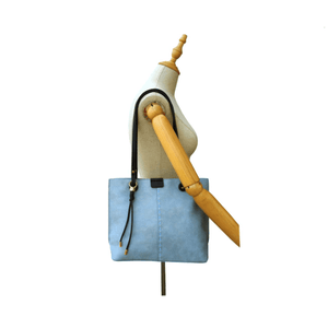Blue handbag on a mannequin with a white background - okotoks hc pharmacy