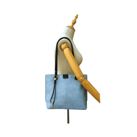 Blue handbag on a mannequin with a white background - okotoks hc pharmacy