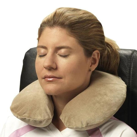 Woman using a beige travel neck pillow in a chair. - okotoks hc pharmacy