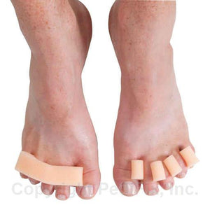 Feet with toe separators on a white background - okotoks hc pharmacy