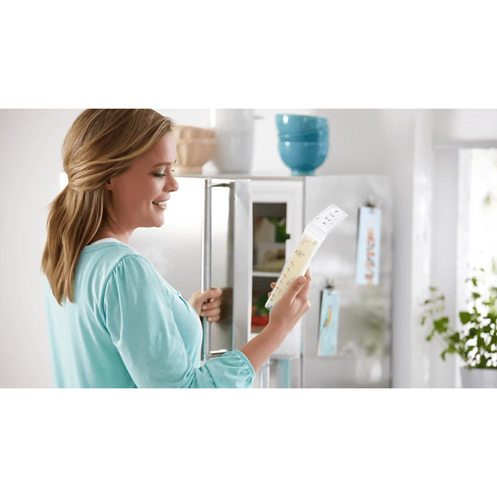 Woman holding a baby bottle in a kitchen setting - okotoks hc pharmacy