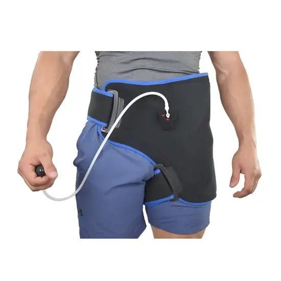 Person wearing a black and blue medical device on their waist with a white hose. - okotoks hc pharmacy