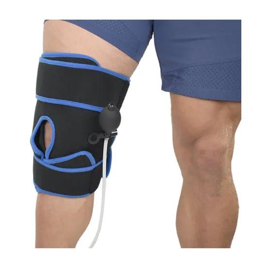 Black and blue knee brace on a person's leg with a white background - okotoks hc pharmacy