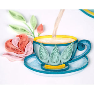 Decorative teacup with floral design being filled with milk, surrounded by paper flowers - okotoks hc pharmacy