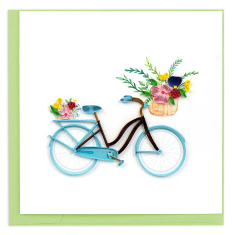 Blue bicycle with flower baskets on a white background - okotoks hc pharmacy