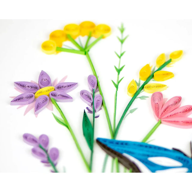 Colorful paper quilled flowers with a blue butterfly on a white background - okotoks hc pharmacy