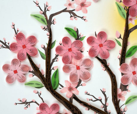 Quilled cherry blossom design with pink flowers and green leaves on a white background - okotok hc pharmacy