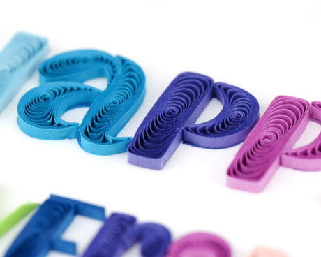 Colorful paper quilling letters on a white background - okotoks hc pharmacy