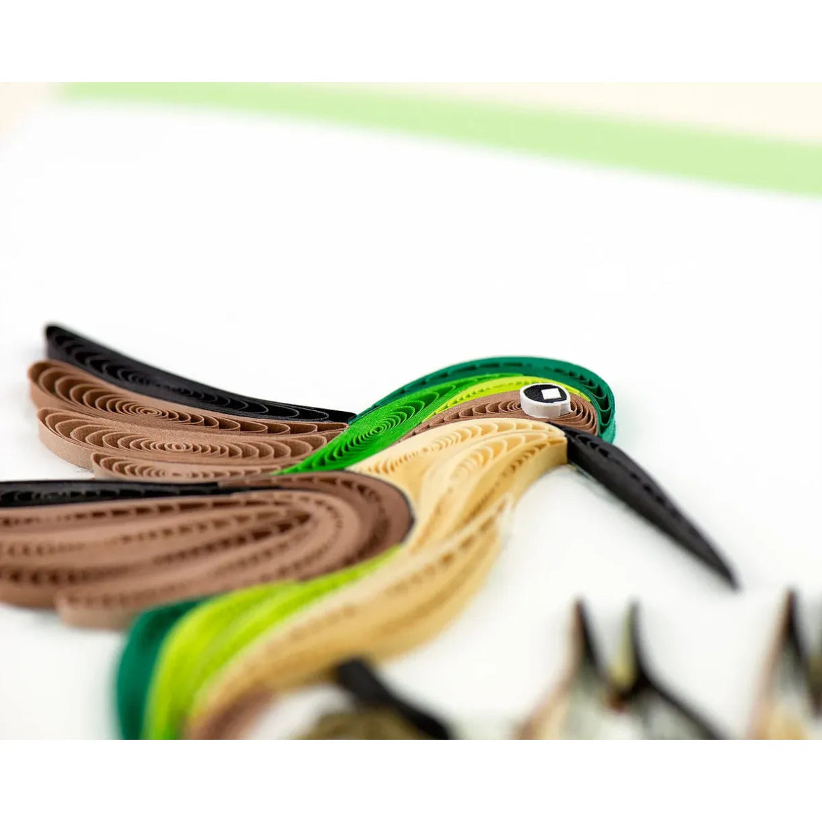 Colorful paper quilled bird on a white background - okotoks hc pharmacy