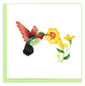 Quilled artwork of a hummingbird and yellow flower on a white background - okotoks hc pharmacy