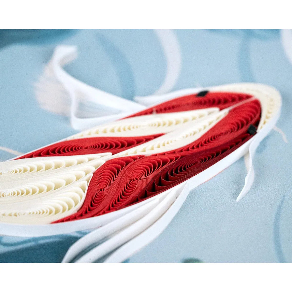 Red and white paper quilled shoe on a light blue background - okotoks hc pharmacy