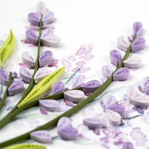 Quilled paper flowers and leaves on a white background - okotoks hc pharmacy