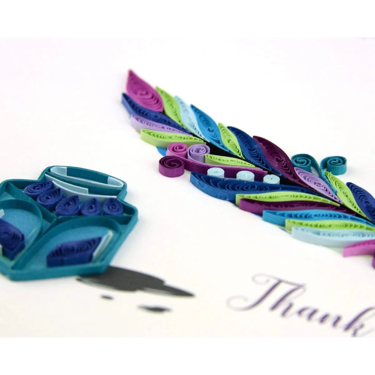 Colorful paper quilling strips with a pair of scissors on a white background - okotoks hc pharmacy