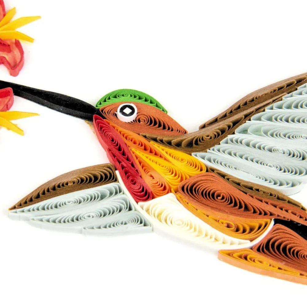 Quilled paper art of a bird with detailed wings on a white background - okotoks hc pharmacy