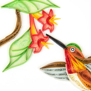 Quilled paper art of a bird, flowers, and leaves on a white background - okotoks hc pharmacy