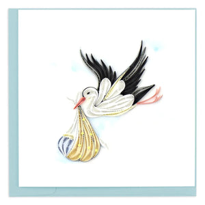Decorative card with a stork carrying a baby wrapped in a rainbow blanket on a light blue background. - okotoks hc pharmacy