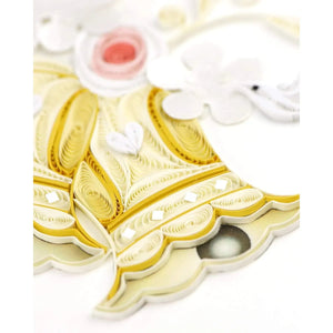 Quilled paper art of a bells with intricate patterns on a white background - okotoks hc pharmacy