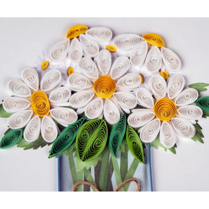 Quilled paper flower art with white petals, yellow centers, and green leaves on a white background. - okotoks hc pharmacy