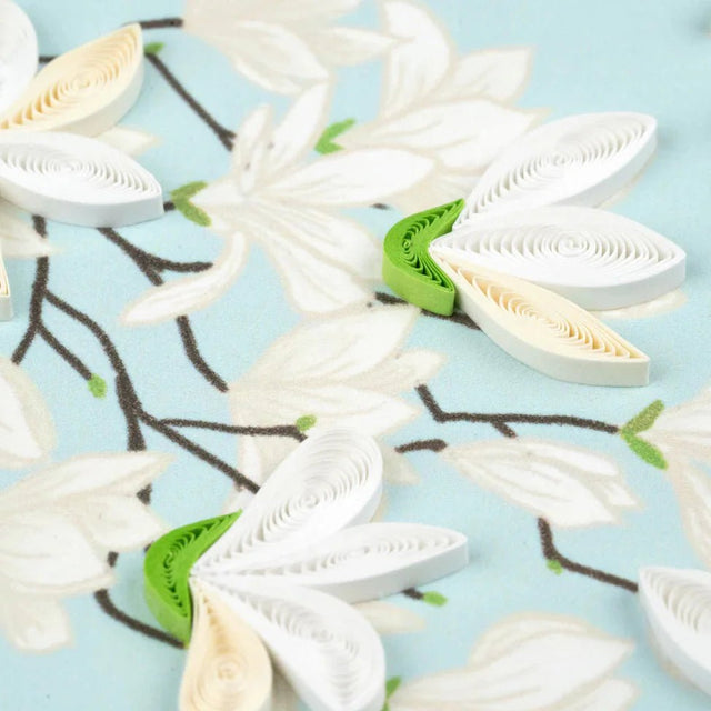 White paper flowers on a light blue background - okotoks hc pharmacy