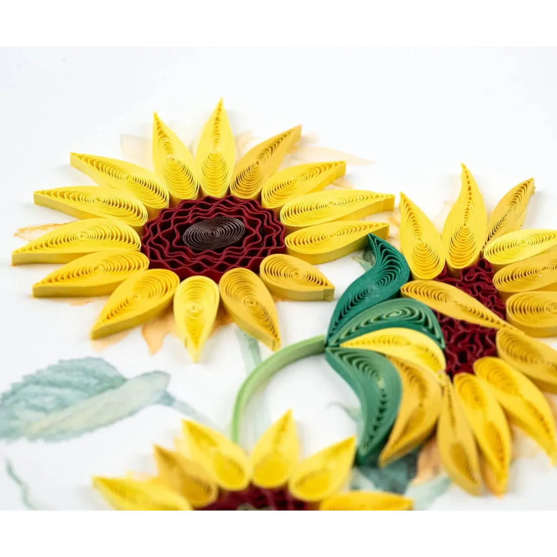 Quilled sunflower designs in yellow, green, and red on a white background - okotoks hc pharmacy