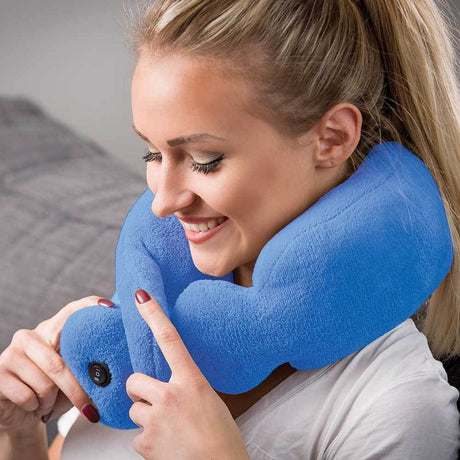 Woman using a blue neck massage pillow in a bedroom setting - okotoks hc pharmacy
