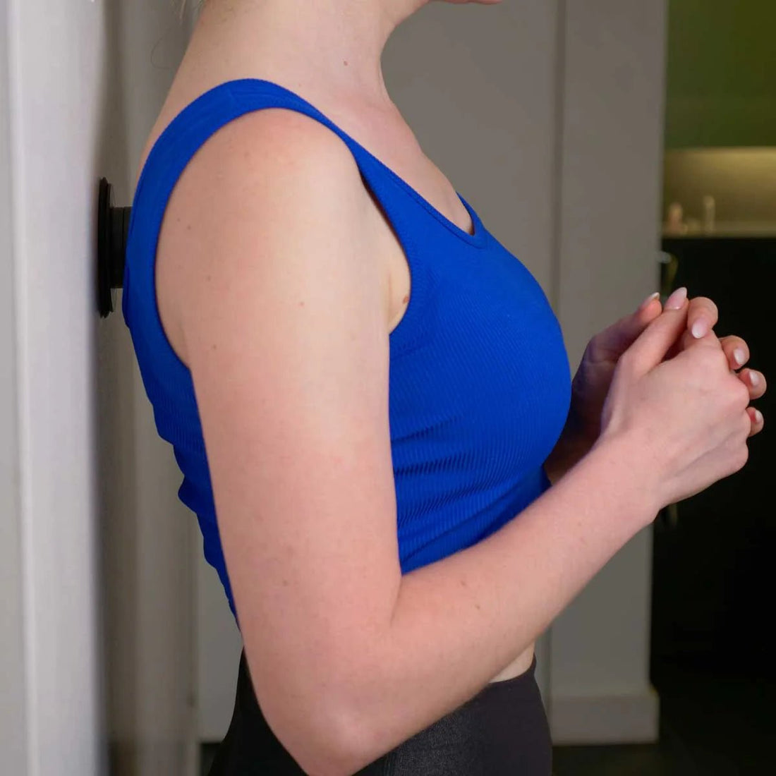 Person wearing a blue tank top in an indoor setting - okotoks hc pharmacy