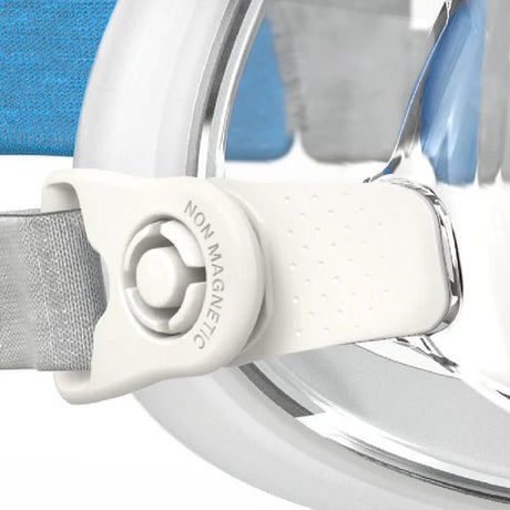 Close-up of a white strap with a non-magnetic label on a blue background - okotoks hc pharmacy