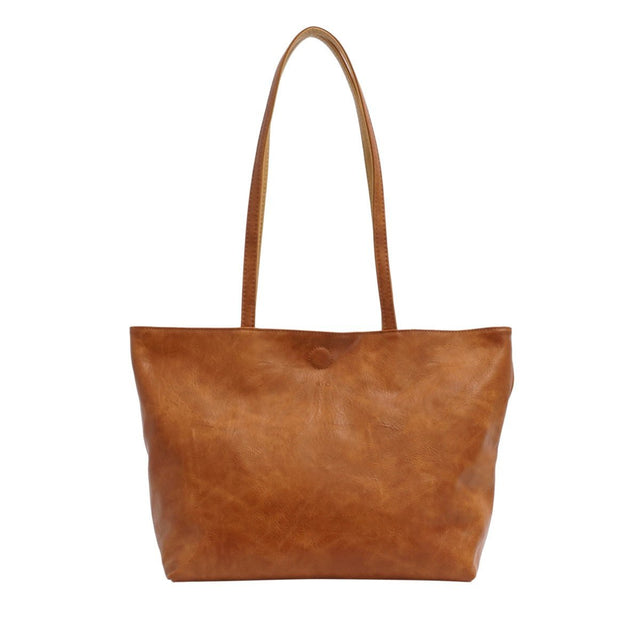 Brown leather tote bag on a white background - okotoks hc pharmacy