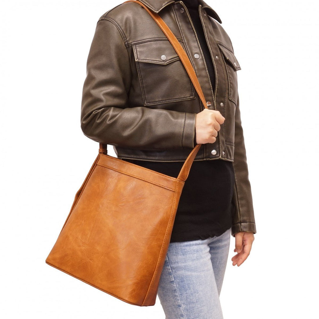 Person wearing a brown leather jacket and holding a matching brown leather bag on a white background - okotoks hc  pharmacy
