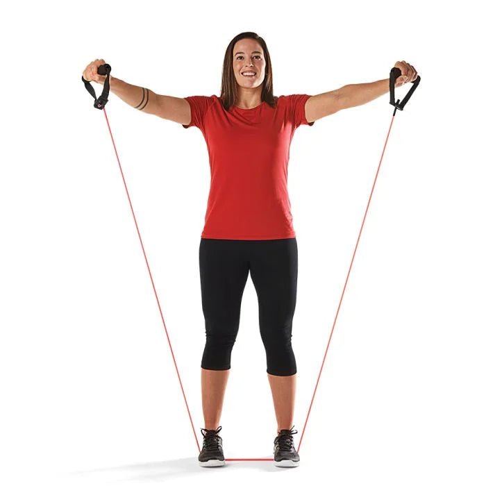 Woman exercising with resistance bands on a white background - okotoks hc pharmacy