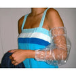 Person wearing a blue dress with a plastic arm cast on a white background - okotoks hc pharmacy