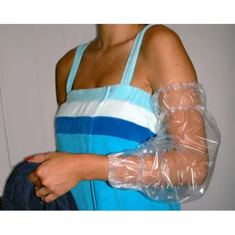 Person wearing a blue dress with a plastic arm cast on a white background - okotoks hc pharmacy