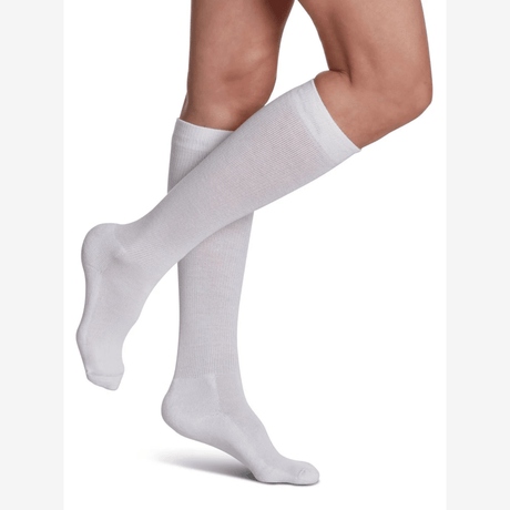 White knee-high socks worn by a person on a white background - okotoks hc pharmacy