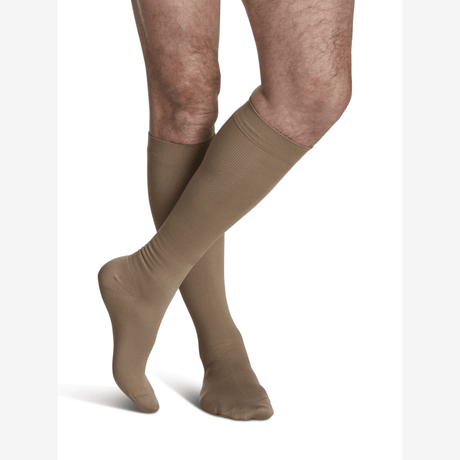 Beige knee-high socks worn by a person on a white background - okotoks hc pharmacy