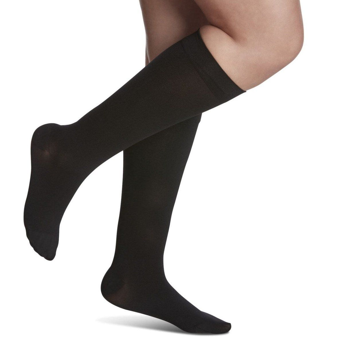 Black knee-high socks worn by a person on a white background - okotoks hc pharmacy