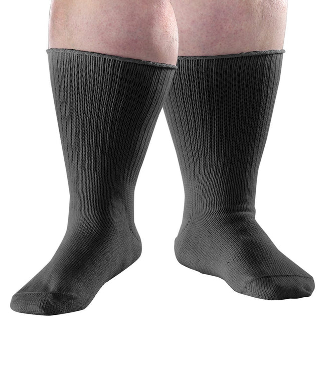 A pair of black ribbed crew socks worn on a person's legs, shown against a plain white background. - okotoks hc pharmacy