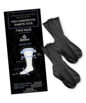 A pair of black non-constrictive diabetic mid-calf socks displayed next to their black retail packaging card on a white background. - okotoks hc pharmacy