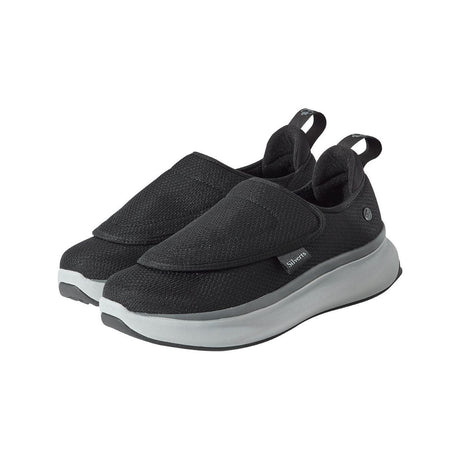 Black slip-on shoes with gray soles on a white background - okotoks hc pharmacy