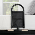 Black bed cane on a white bed with a blurred window in the background - okotoks hc pharmacy