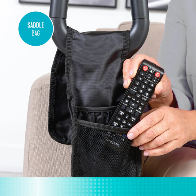 Person holding a remote control with a black saddle bag attached to couch cane - okotoks hc pharmacy