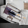 Bed rail with cup holder attached to a bed in a bedroom setting - okotoks hc pharmacy
